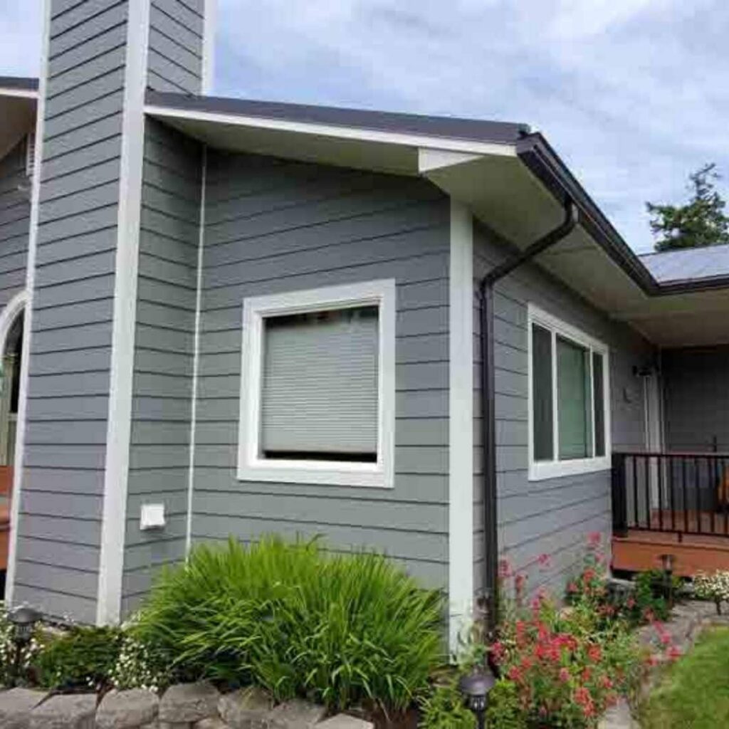 White trim on a gray house with James Hardie products installed